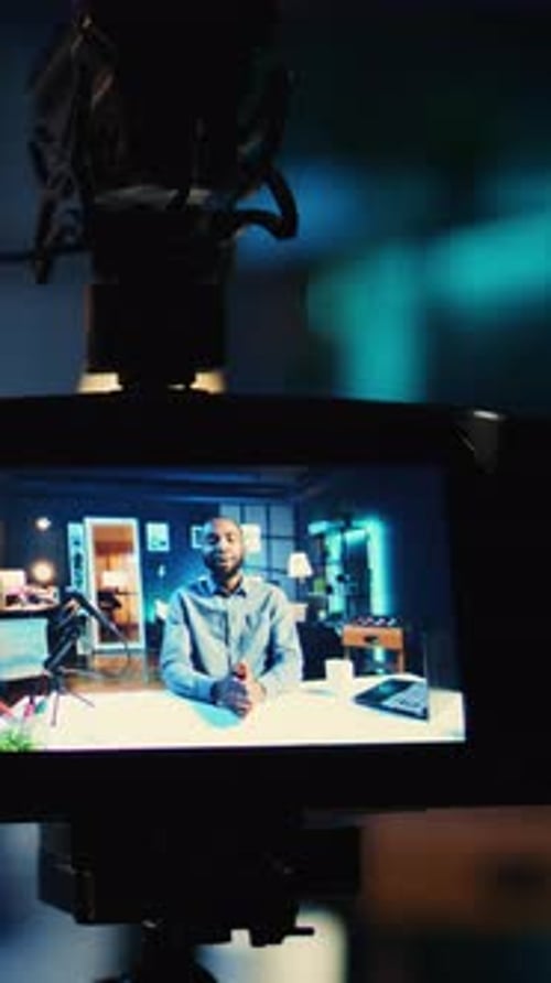 Man Broadcasting Online in Home Studio Displayed on Monitor