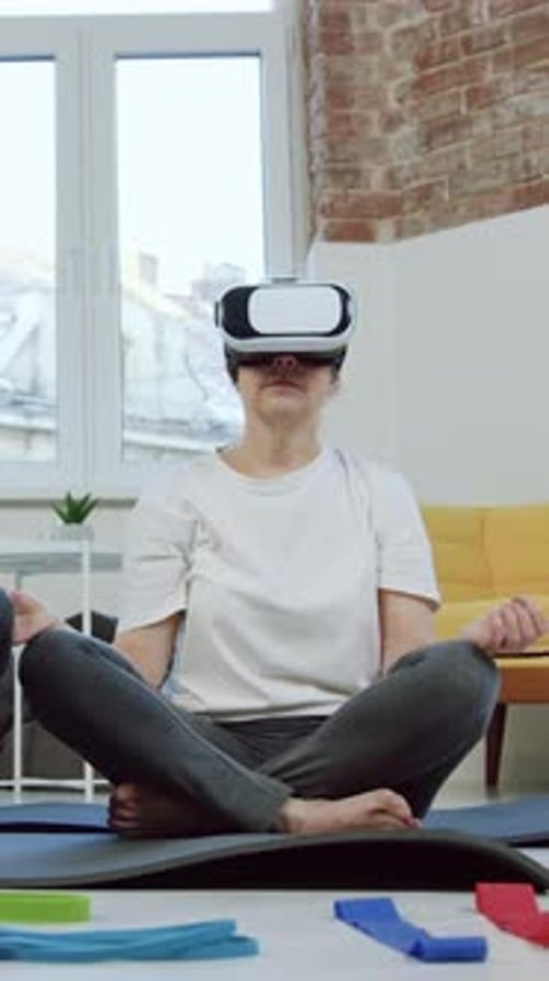 Woman Meditating Wearing VR Headset on Yoga Mat