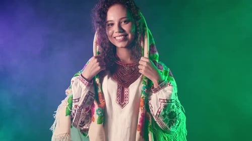 Woman in Embroidered Dress Smiling With Headscarf