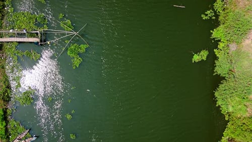 Drone view from top of natural green river with fishnet