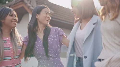 Young Women Smiling and Laughing Together Outdoors