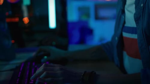 Close Up of an Excited Gamer Playing Online Video Game on His Personal Computer. Room and PC have C