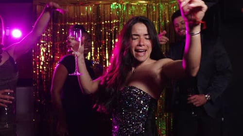 Friends Celebrating at Intimate Dark Party with Champagne