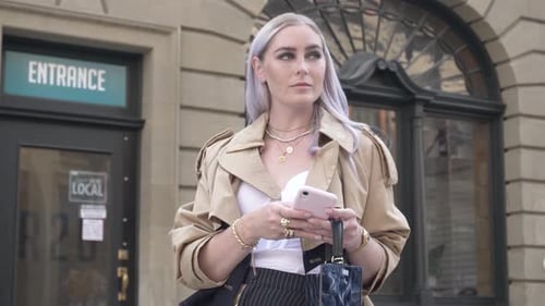 Stylish Woman with Platinum Hair Using Smart Phone in City Adult