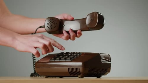 Hand Holding Old and Retro Telephone Vintage Phone Headset Isolated on Grey Studio Background Woman