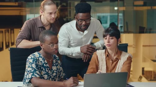 Business Team Discussing Project on Laptop in Modern Office