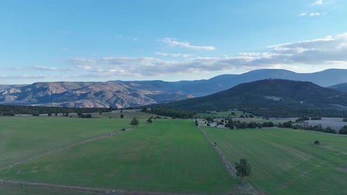 Aerial View of Green Fields and Mountains
