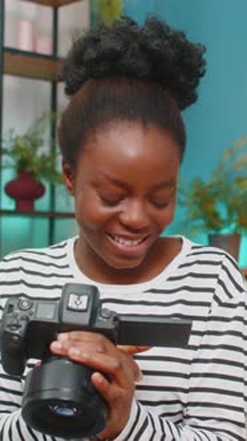 Smiling Woman Holding Camera Indoors in Vertical Video