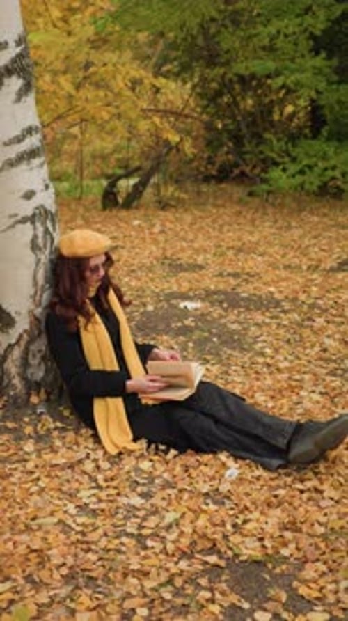 Woman Reading a Book by a Birch Tree