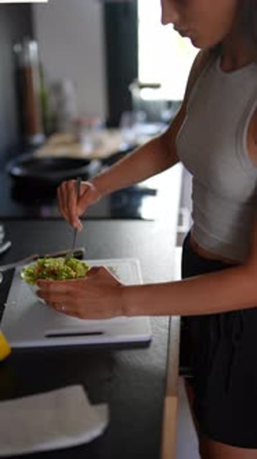 Woman Making a Salad in a Modern Kitchen