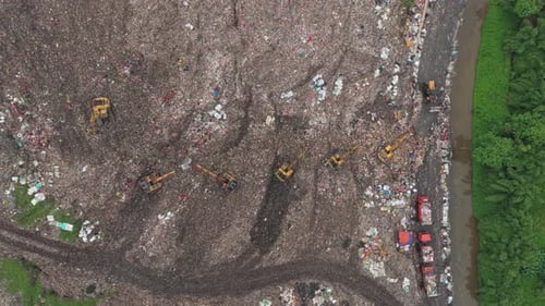 Aerial view of a large landfill with excavators working