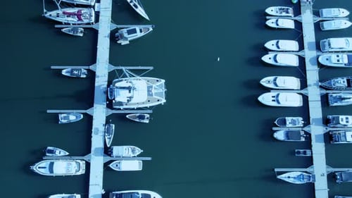 Aerial view of boats docked in a marina with calm waters