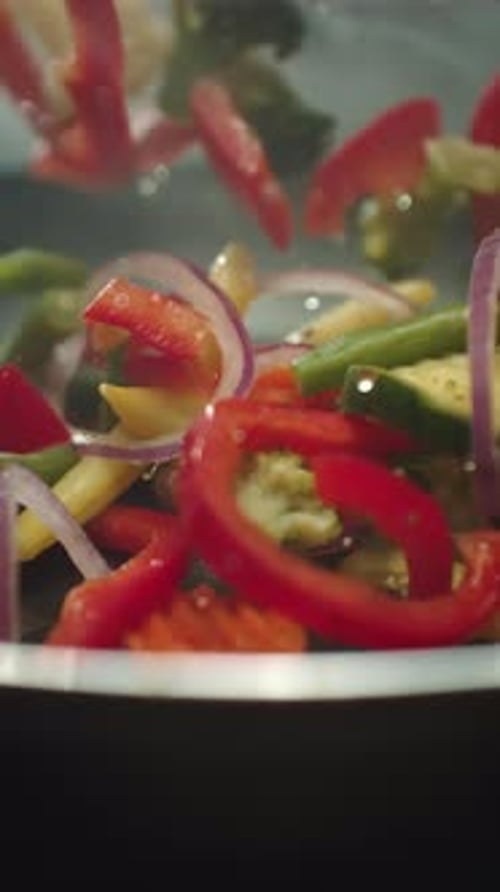 Closeup of Chef Preparing and Throwing Vegetable Mix on Frying Pan Preparation Fresh Appetizing Food