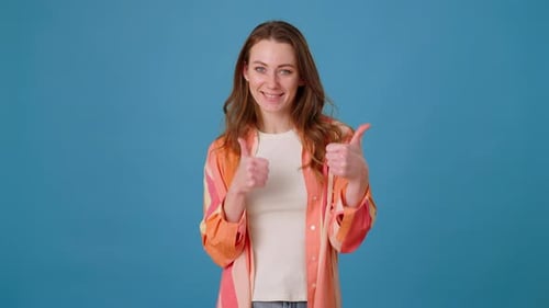 Happy Woman Gives Double Thumbs Up on Blue