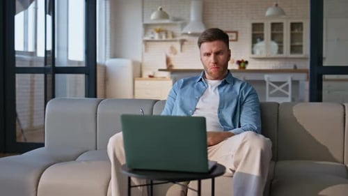 Man Working from Home, Writing in Notebook