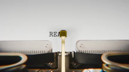 Old mechanical typewriter typing Reason in a close-up view.