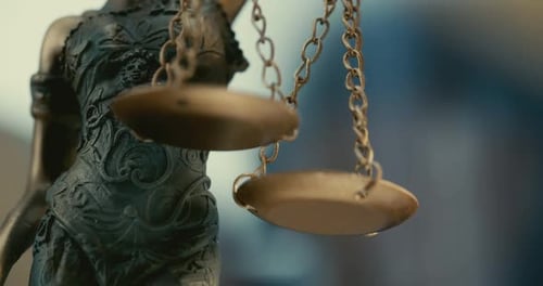 Blindfolded Lady Of Justice: Statue Depicting Equality with Scales, Legal Symbol of Integrity.