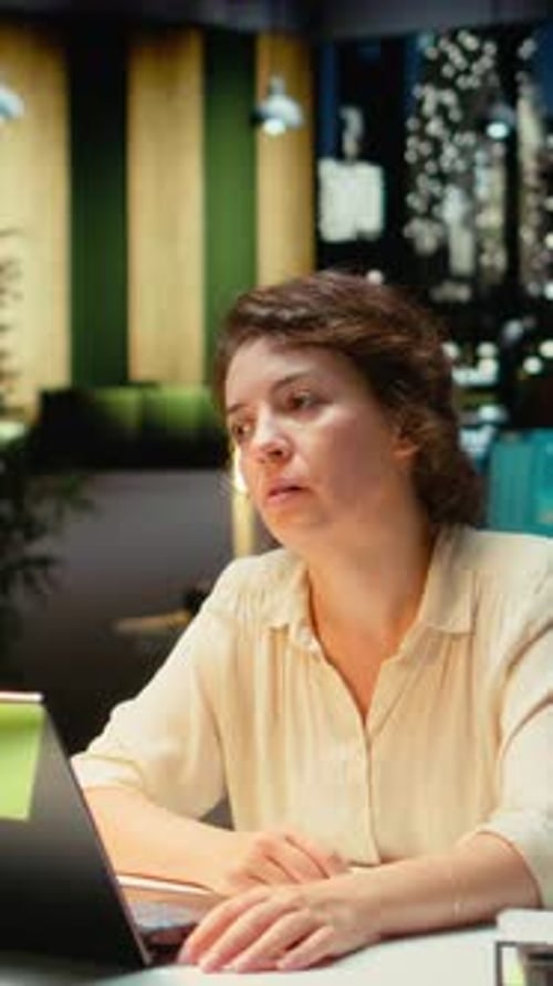 Woman working at computer in modern co-working space