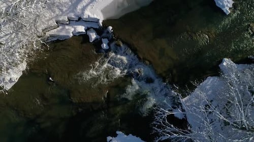 Flight Approaching a Mountain Wild Clear River on a Winter Sunny Day