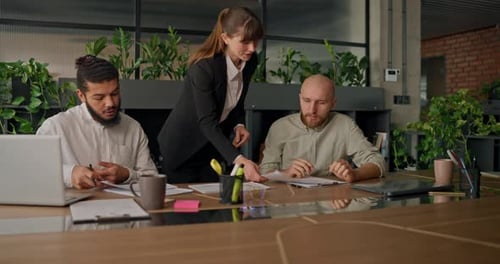 Businesswoman Presents Her Report to Colleagues at the Start of a Meeting Sharing Key Data Insights