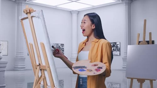 Female Looking At The Picture On Canvas Then Saying Wow While Painting In Gallery
