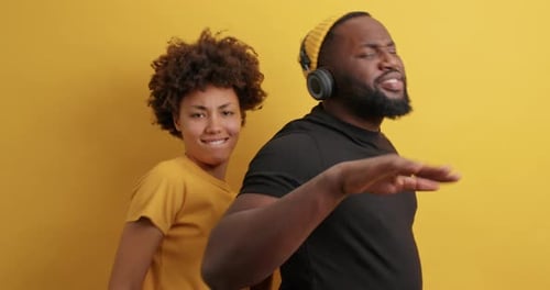 Positive Dark Skinned Young African American Woman And Man Point Directly At Camera Have Fun Move...