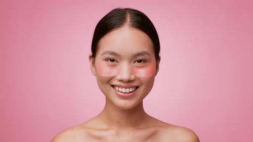 Smiling Woman Wearing Eye Patches for Beauty Treatment