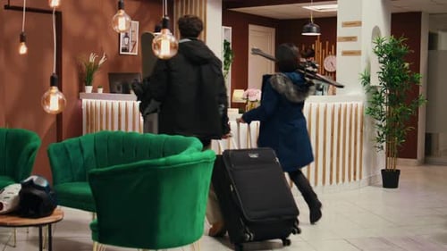 Couple Checking In at a Hotel with Ski Equipment