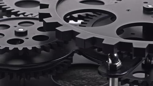 Rotating Gears Turning in Close Up of Clock