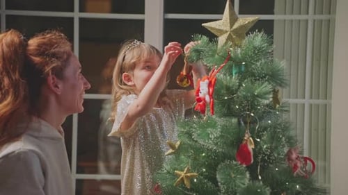 Mother and Child Decorating Christmas Tree Together