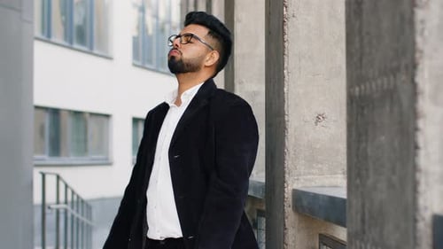 Stressed Man Sitting Outside Office Building