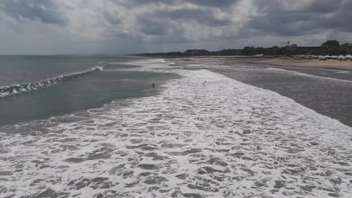 Aerial View of Foamy Shoreline Ridge and Tidal Wash Along Kuta Beach Bali