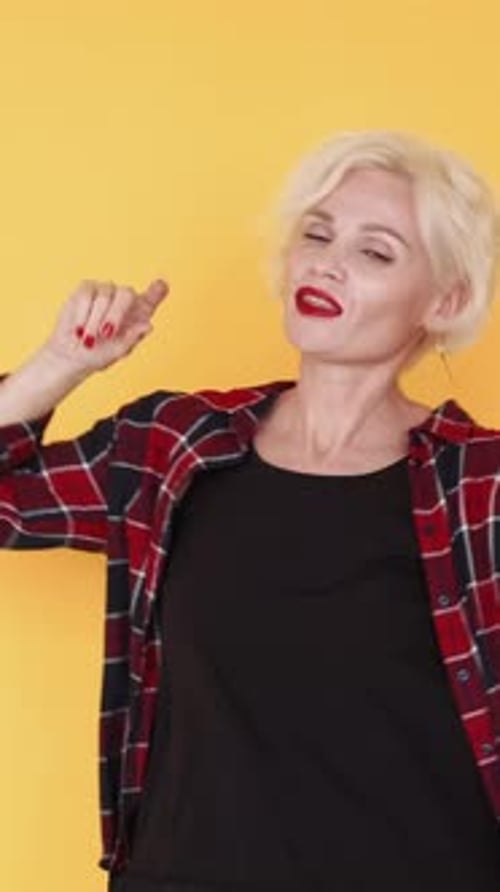 Blonde Woman Dancing on Yellow Background