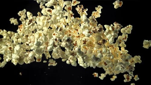 Popcorn Flies Up and Falls Down On a Black Background Filmed on a Highspeed Camera at 1000 Fps