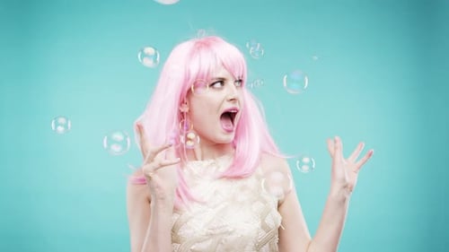 4k video footage of a young woman dancing against a studio background