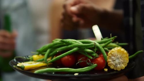Plate of green beans, tomatoes, and corn