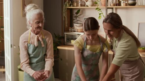 Three Generations of Women Baking Together in Kitchen