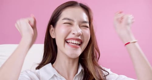 Happy Woman Cheers with Enthusiasm Indoors