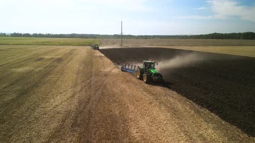 Tractors plowing the field in Ukraine