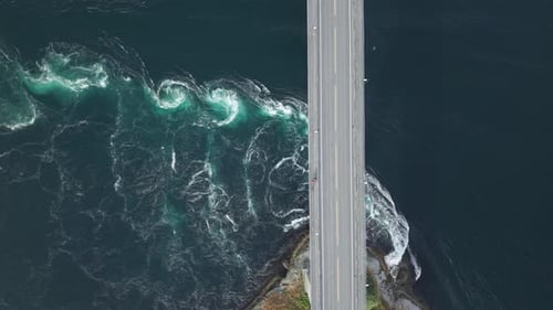 Powerful Tidal Currents Swirl Beneath a Bridge at Saltstraumen in Norway - Aerial Topdown Shot