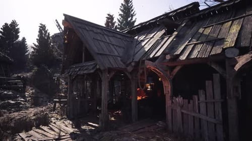 Wooden Buildings in a Forest with Warm Light Filtering Through Trees