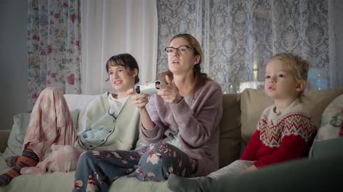 Family Gaming Together on Couch at Home