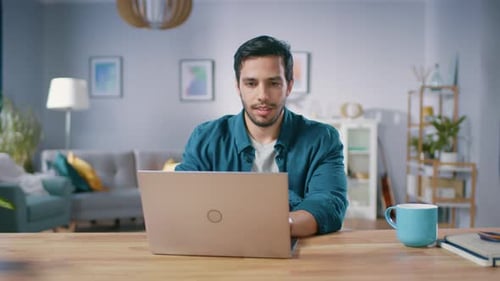 Man Working on Laptop in Bright Modern Home