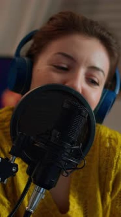 Woman Speaking into Microphone Wearing Headphones Close Up