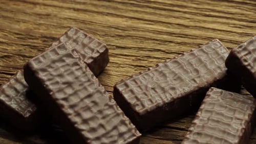 Delicious Wafers Covered in Chocolate on Wooden Background