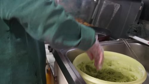 Chef Preparing Bright Green Food in Kitchen