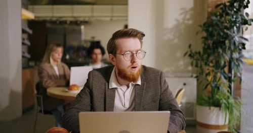 Worried Businessman Or Investor Sitting In Cafe Looking At Display Of Laptop Thinking About Future