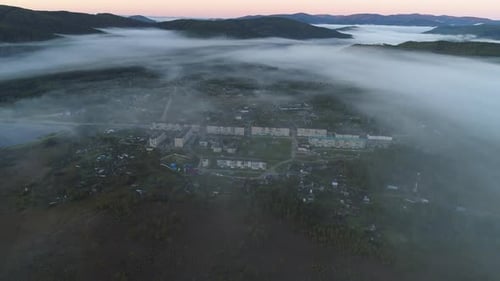 Aerial Panoramic Landscape Fog Covers Little Village in the Valley Between the Hills Beautiful