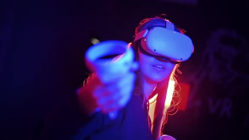 Woman Using Virtual Reality Headset in Dark Setting