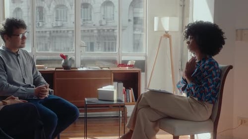 Young Adults in Therapy Session with Professional